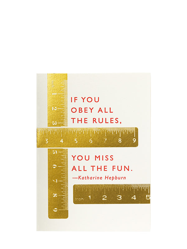 A rectangular greeting card featuring a gold metallic rulers across and a red text quote by Katharine Hepburn: 'IF YOU OBEY ALL THE RULES, YOU MISS ALL THE FUN. -Katharine Hepburn', shown on a clean white background.