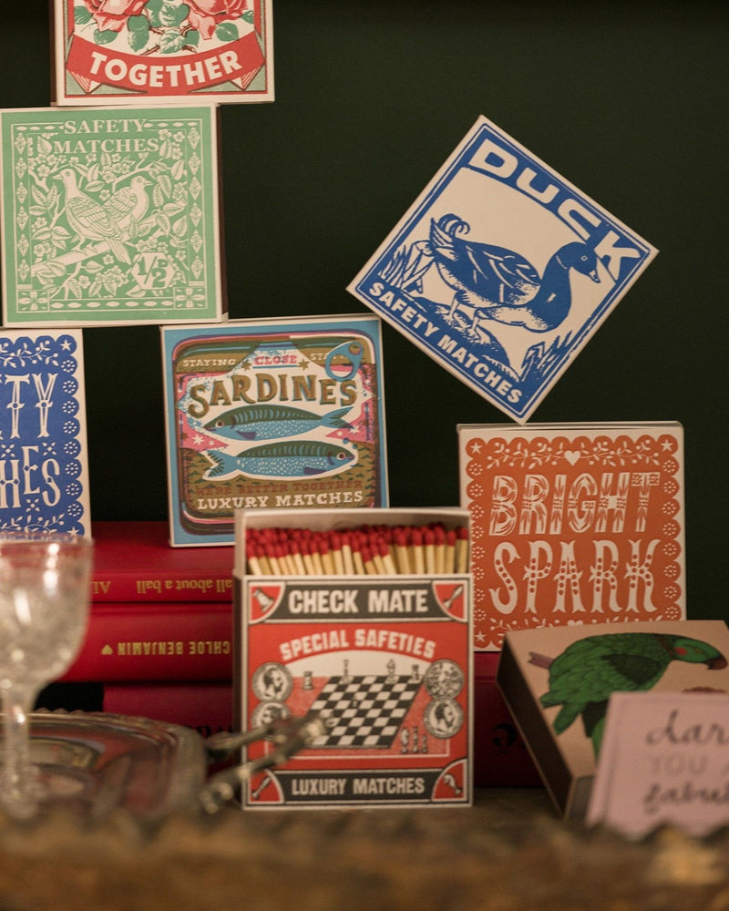 Collection of vintage matchbox labels on a dark background