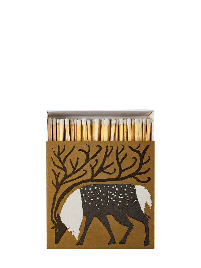 A matchbox with a brown cover featuring a black and white deer design with antlers, shown open with wooden matches inside on a white background.