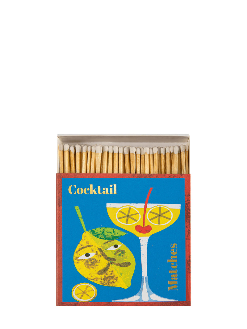 Matchbox with cocktail-themed design on a white background