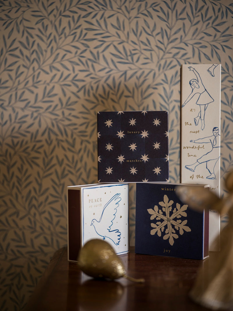 Decorative books with artistic designs on a patterned wall background