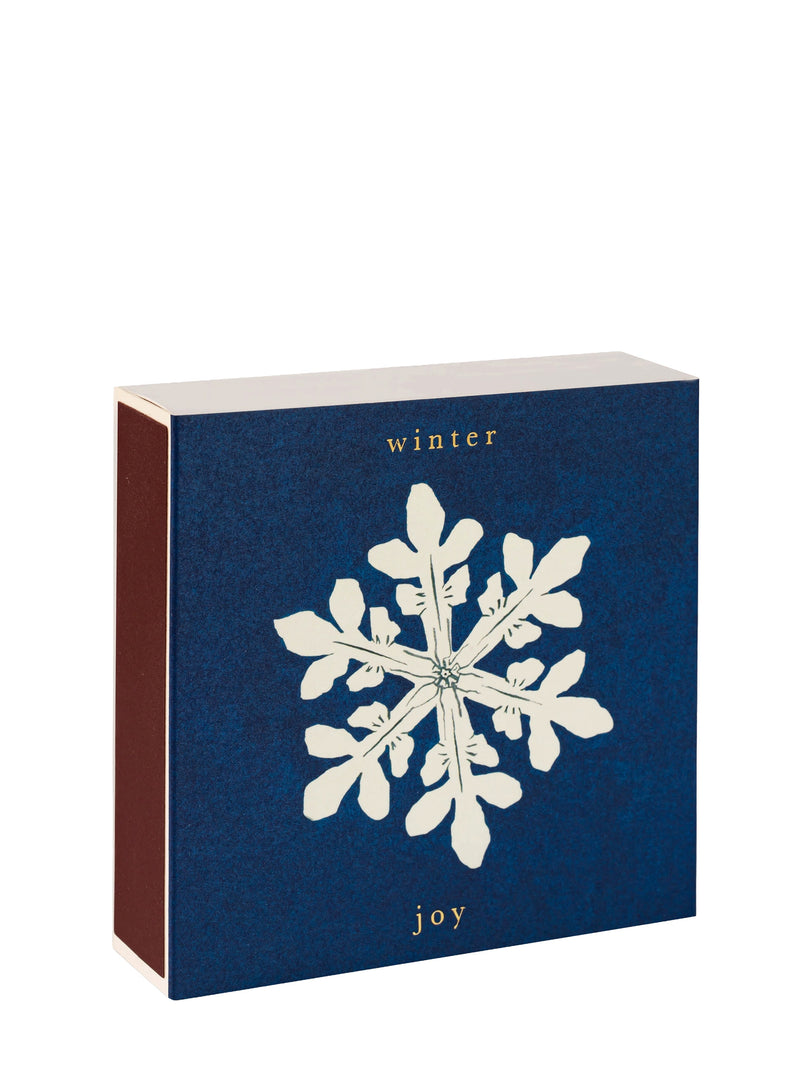 Blue match box with a white snowflake design and text on a white background