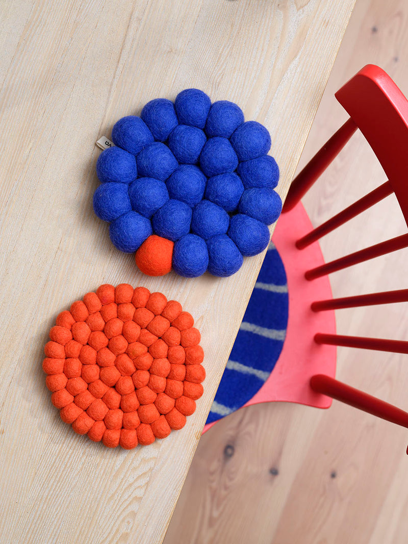 Round felted wool trivet, coral