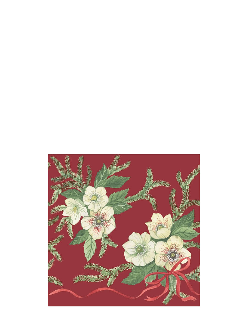 A square decorative printed napkin featuring a red background with green pine branches, white flowers, and a red ribbon, centered on a plain white canvas.