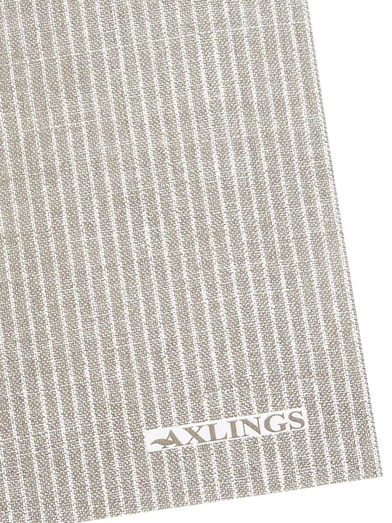 A close-up of a paper napkin imitating textured woven fabric with vertical white stripes on a taupe-beige background, featuring a white rectangular brand patch with the word AXLINGS near the bottom.