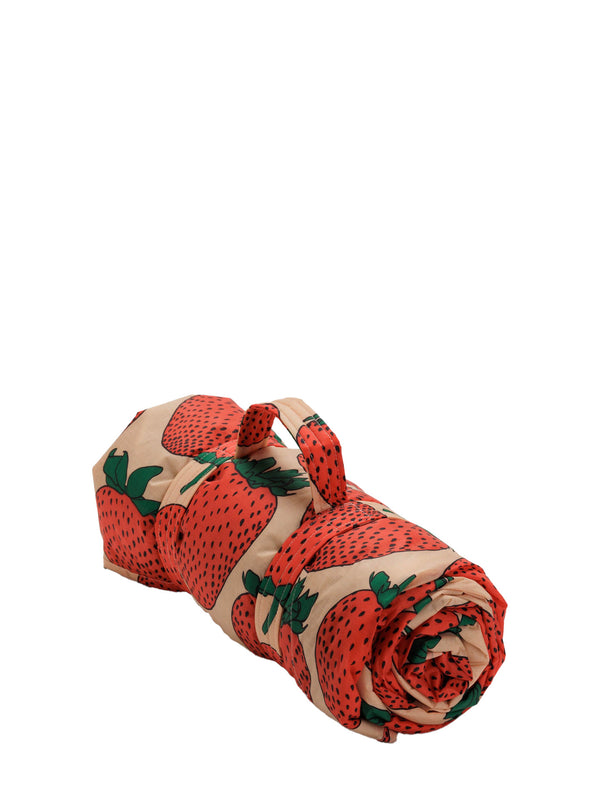 Rolled-up fabric with strawberry pattern on a white background
