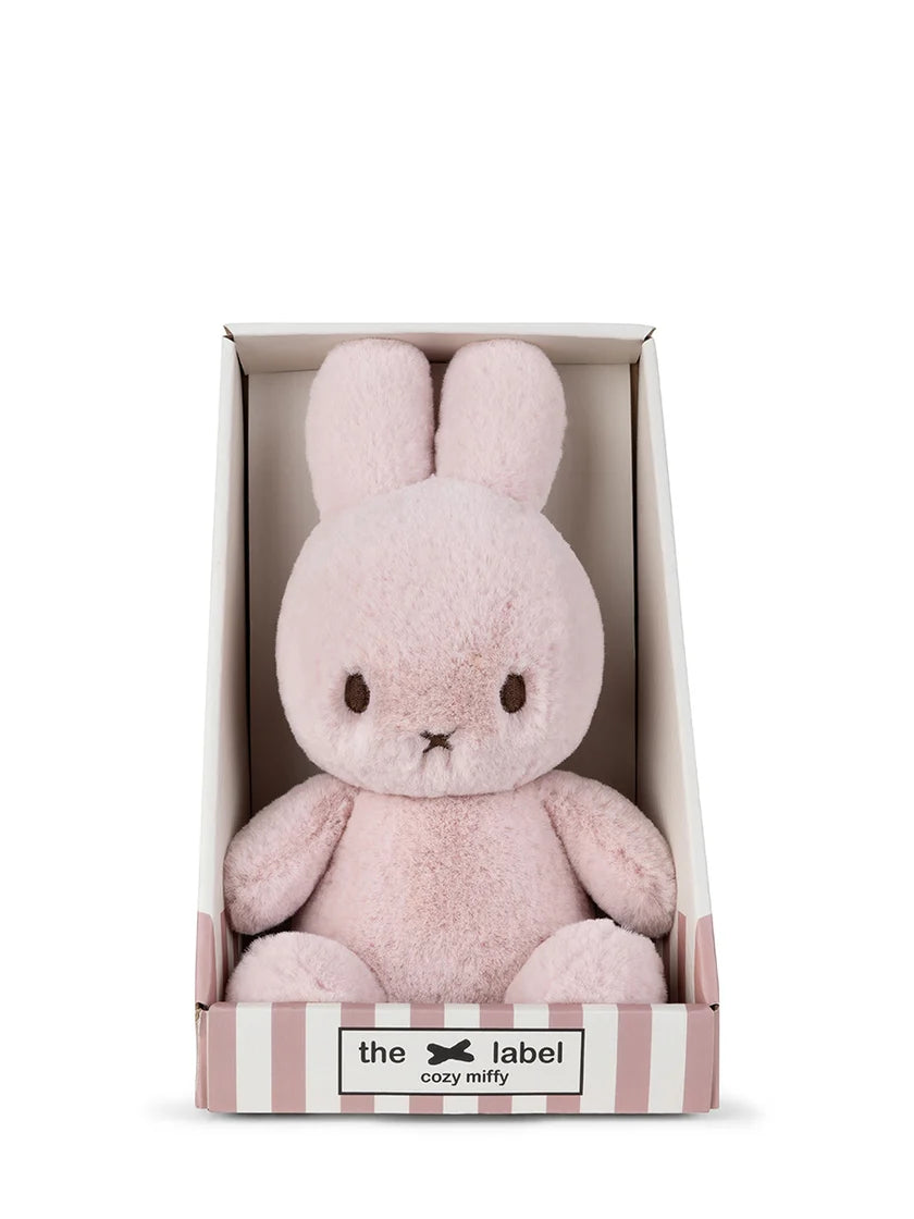 Pink plush bunny toy in a box with 'the label' branding on a white background