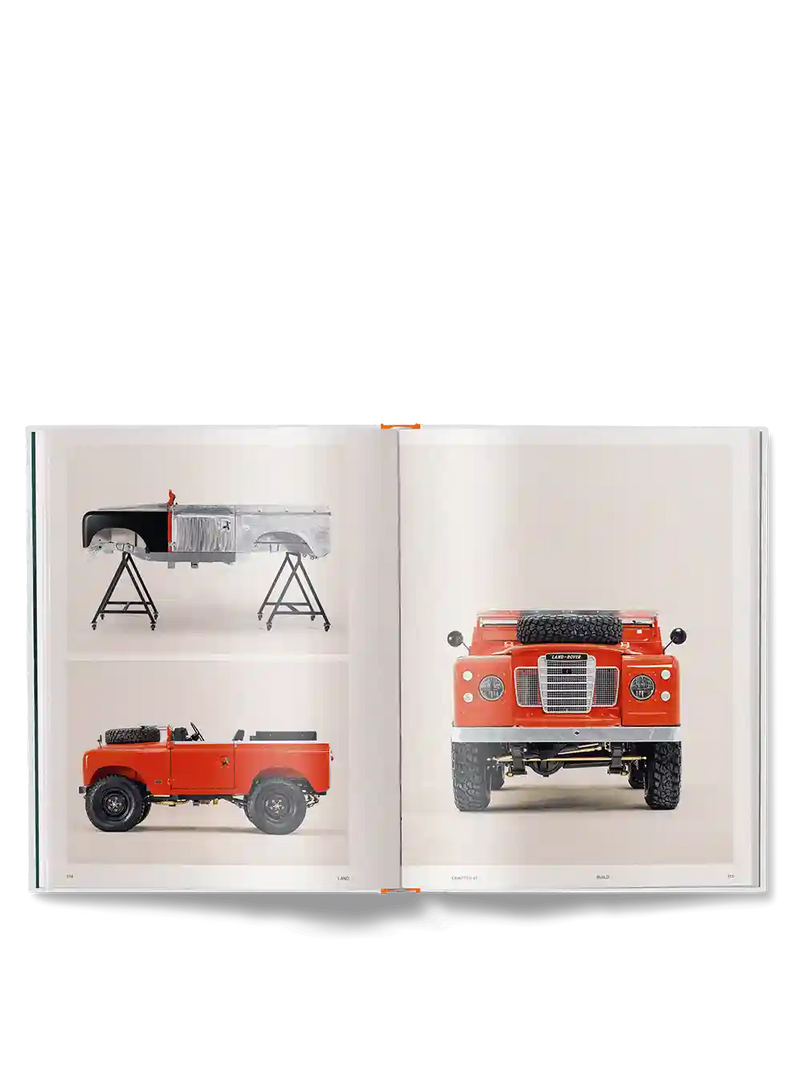 An open book showing printed photographs of a red off-road vehicle, including a full front view on one page and a rear/side view on another page, photographed against a light gray background.