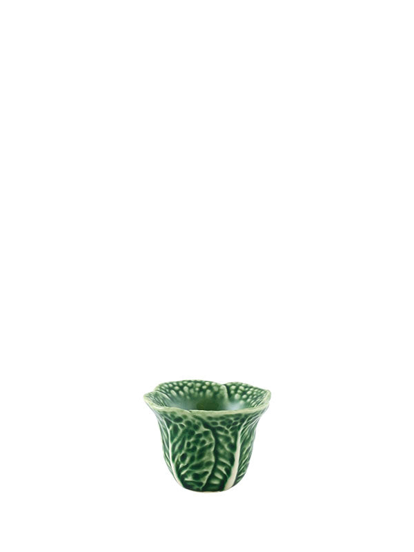 A green earthenware egg cup with a leaf pattern.
