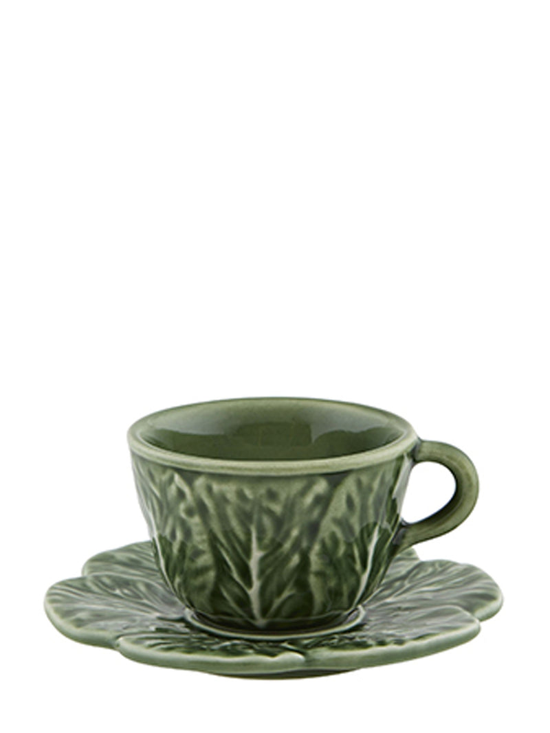 Green ceramic coffee cup and saucer with cabbage leaf pattern on a white background