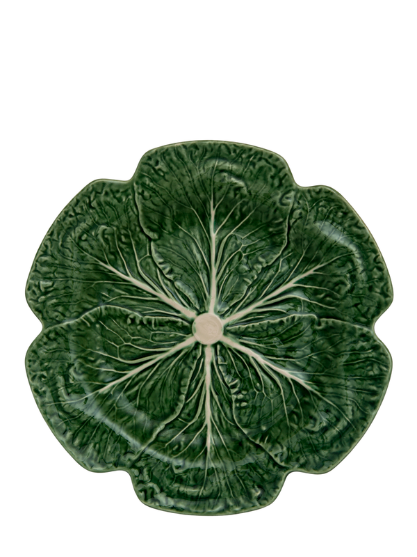 A large, round, green earthenware dinner plate with hand-painted details resembling cabbage leaves.