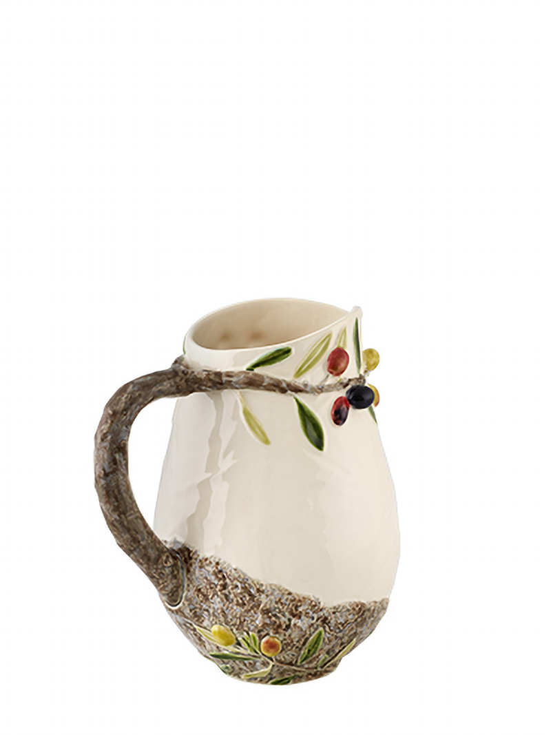 A beige ceramic pitcher with hand-painted olive motifs and natural elements, such as a branch extending from the handle, against a white background.