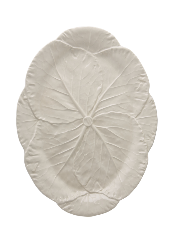 A large oval earthenware platter in creamy ivory color with a leaf-like pattern.