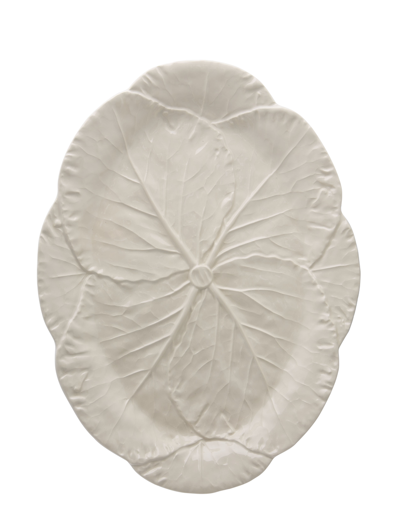 A large oval earthenware platter in creamy ivory color with a leaf-like pattern.