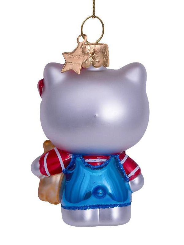 Glass ornament of a cat character with a blue dress and red sweater, hanging from a gold chain.