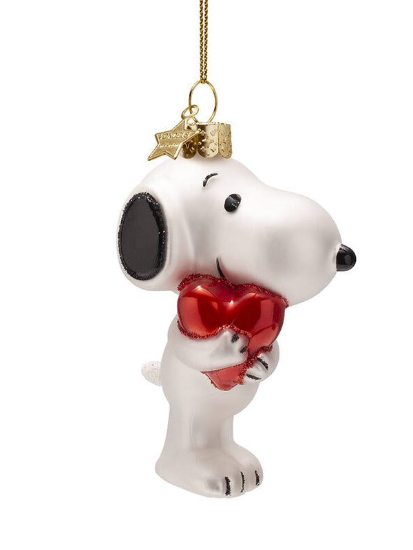 Snoopy ornament holding a red heart with a gold tag on a white background