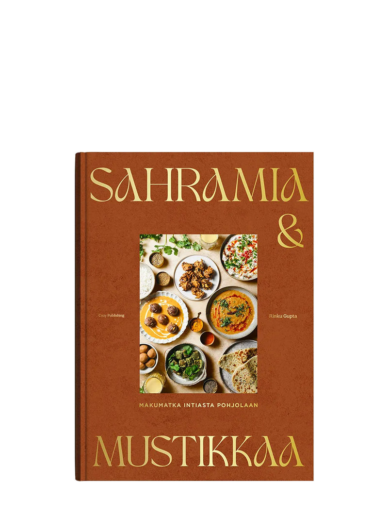 A cookbook titled "SAHRAMIA & MUSTIKKAA" with a subtitle 'Makumatka Intiasta Pohjolaan' by Rinku Gupta for Cozy Publishing' with a warm brown cover, gold lettering, and a central food photography panel showing various dishes of curry, chili and yogurt sauces, creamy salads, naan bread, balls and crispy bites, set against a plain white background.