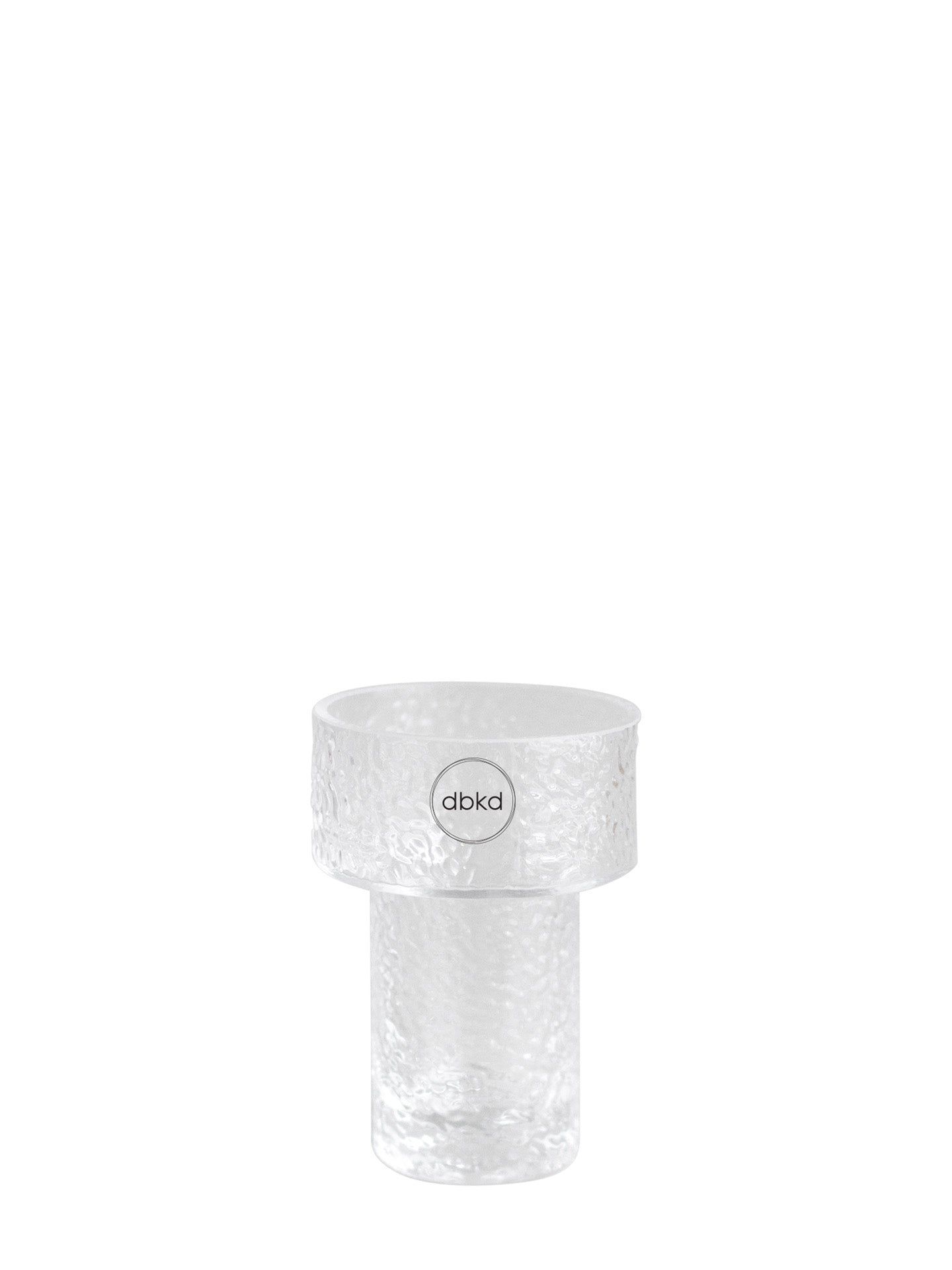 A clear textured glass flowers vase with a wide top rim and a cylindrical base, featuring a circular logo sticker with the brand name 'dbkd' in the center.