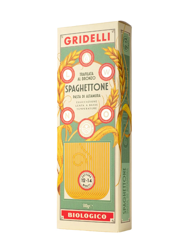 A boxed package of Gridelli spaghetti tonnato biologico pasta, shown standing upright on a light gray background. The packaging features a vintage-style cream and green design with red accents, wheat illustrations, and a window showing yellow pasta strands inside.