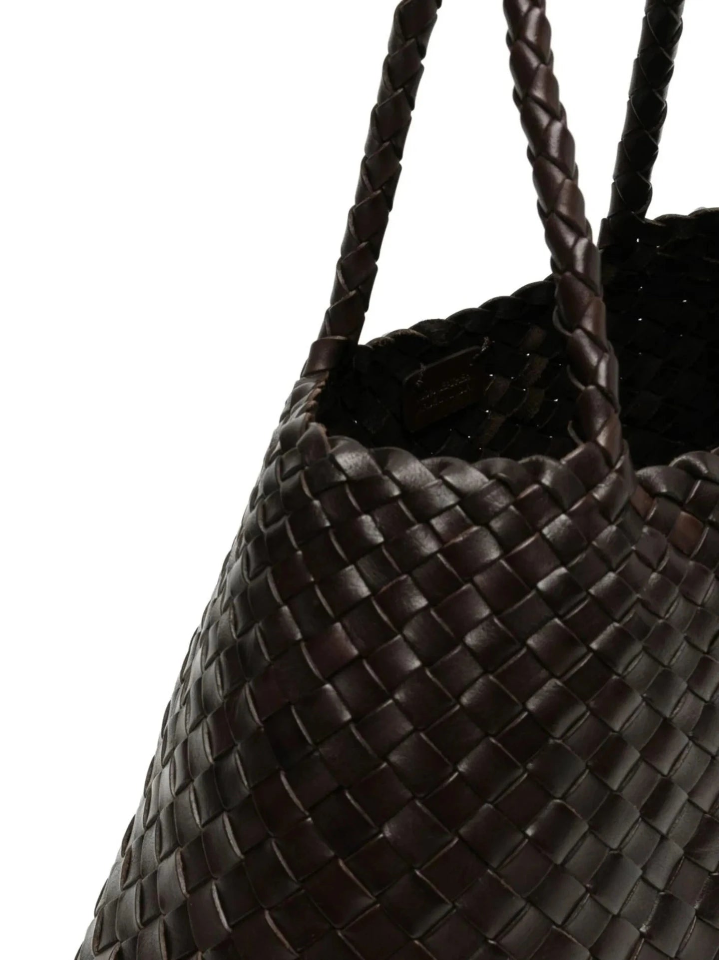 Close-up of a woven black handbag with braided handles on a white background