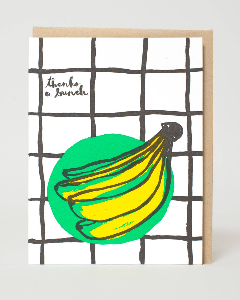 Greeting card with a drawing of bananas and text on a grid background
