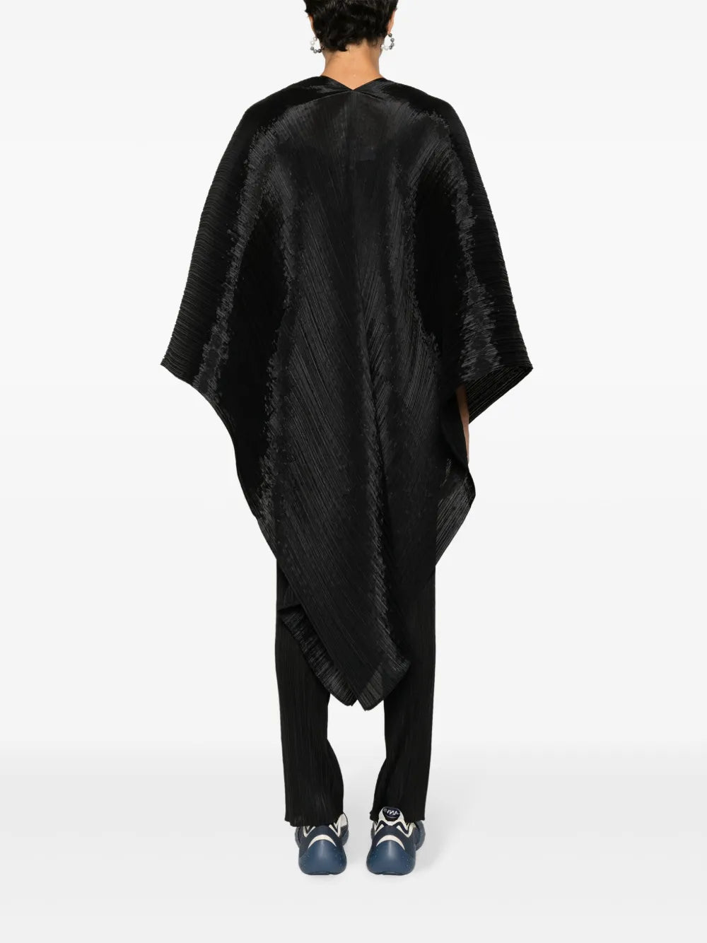 Person wearing a black poncho on a white background