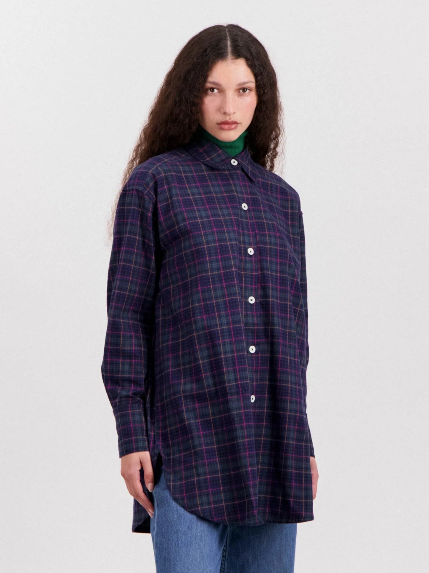 Person wearing a plaid shirt on a white background
