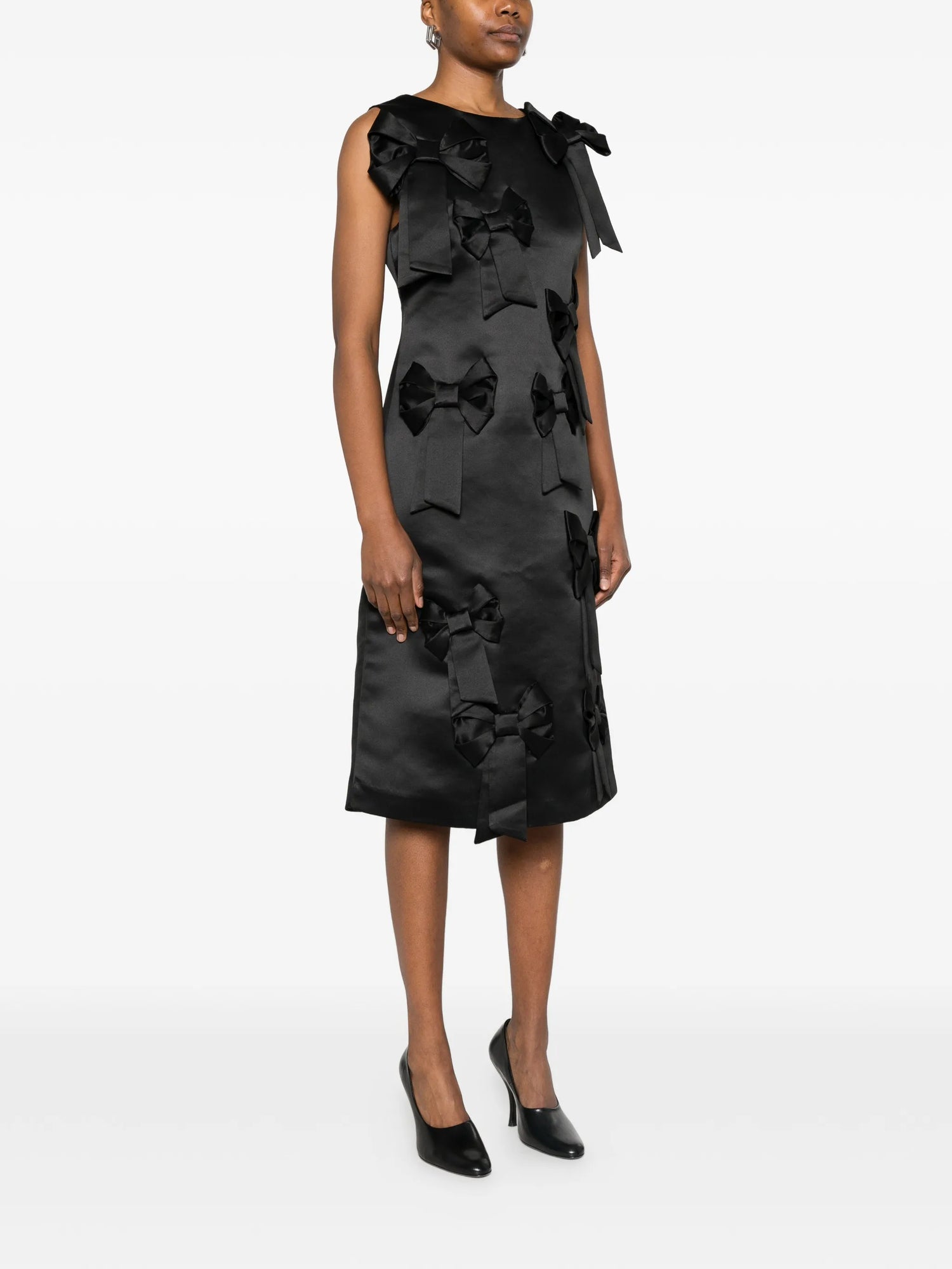 Black dress with bow details on a white background