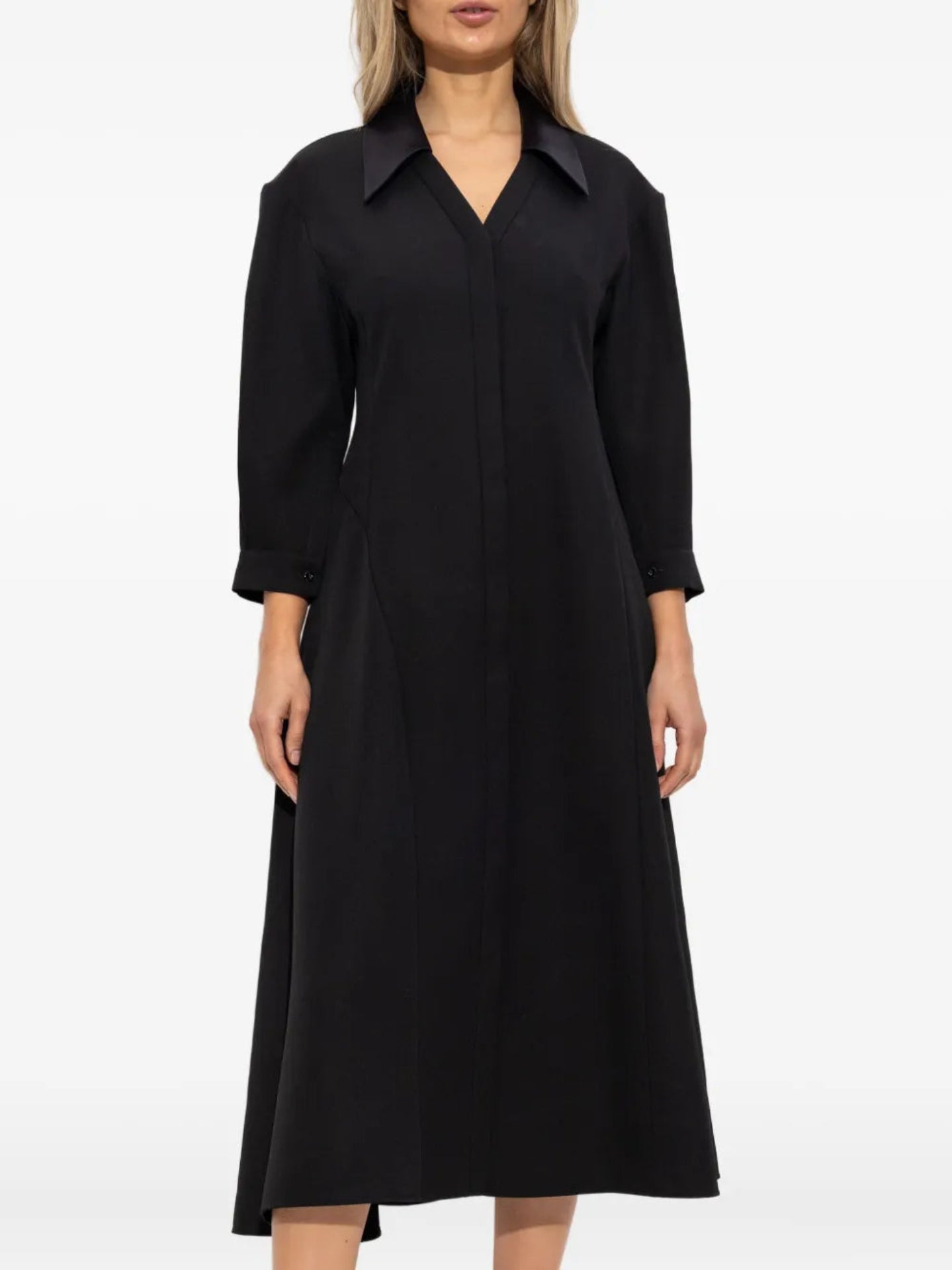 Black dress worn by a model on a white background