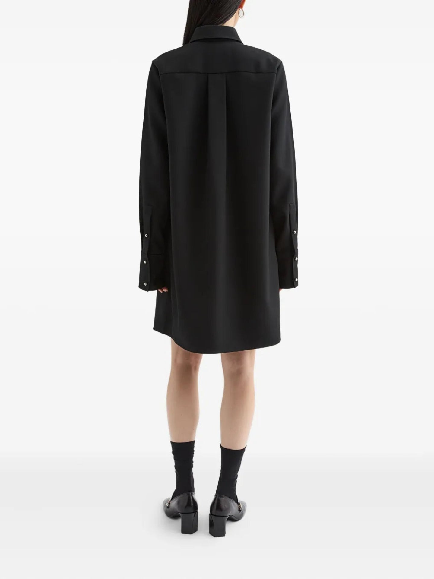 Person wearing a black coat on a white background