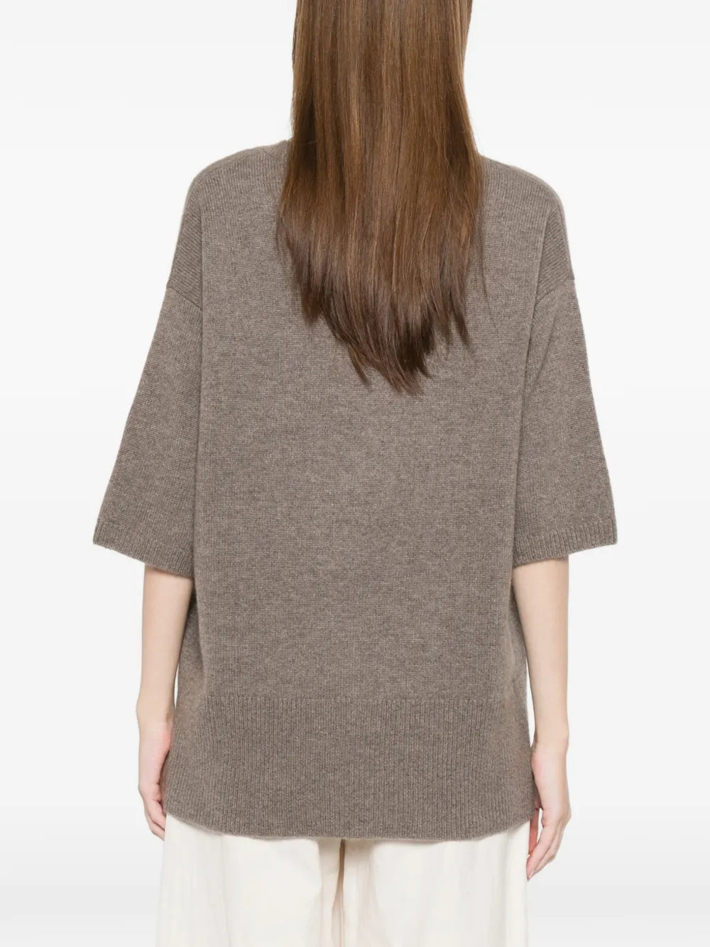 Person wearing a brown sweater on a white background