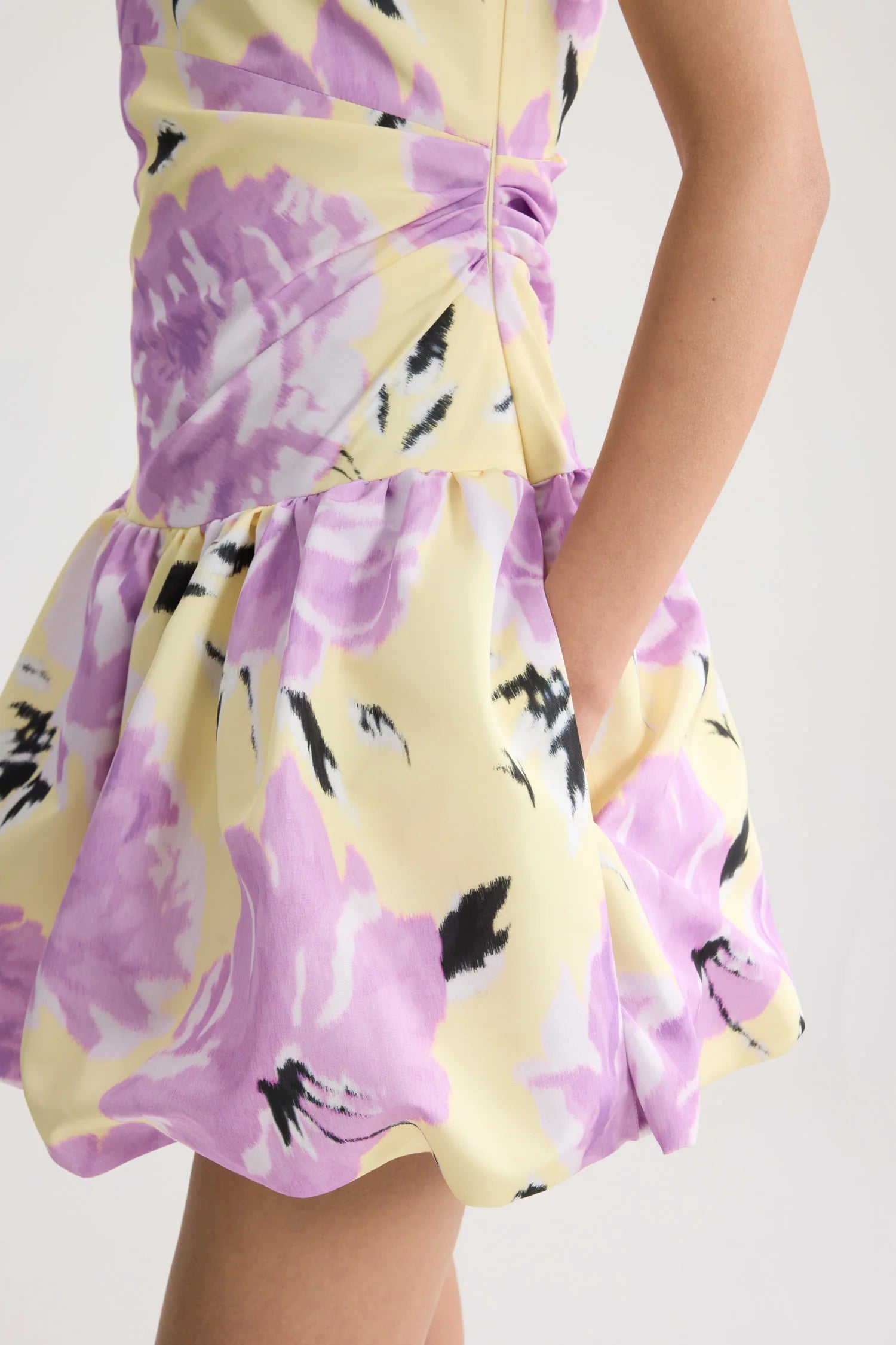 Yellow dress with purple floral pattern on a white background