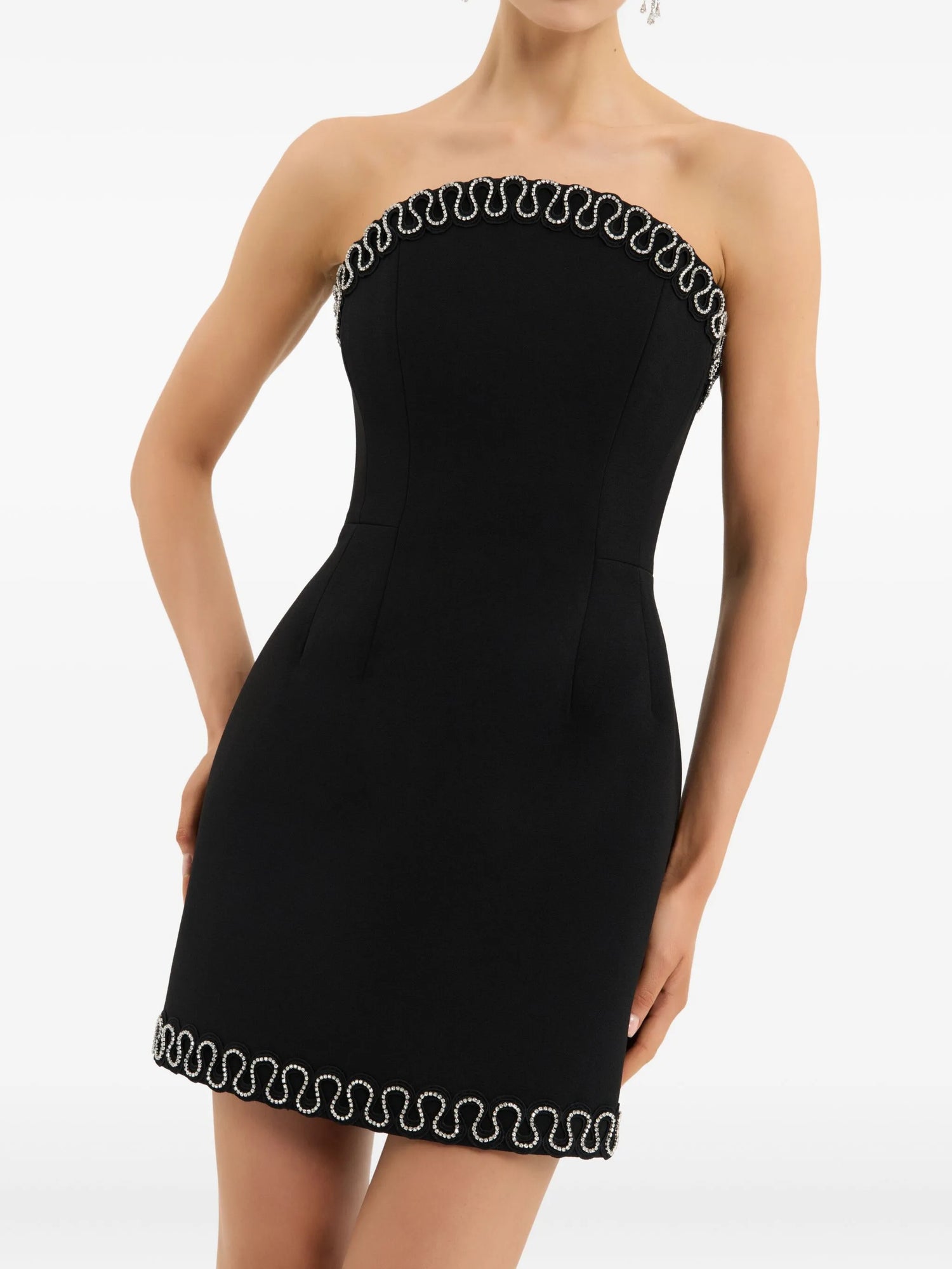 Black strapless dress with decorative trim on a white background