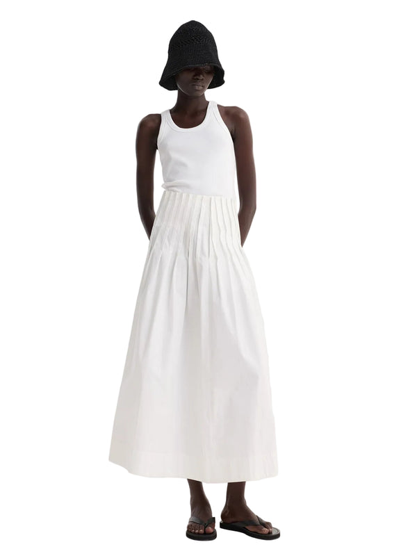 Person wearing a white dress and black hat on a white background