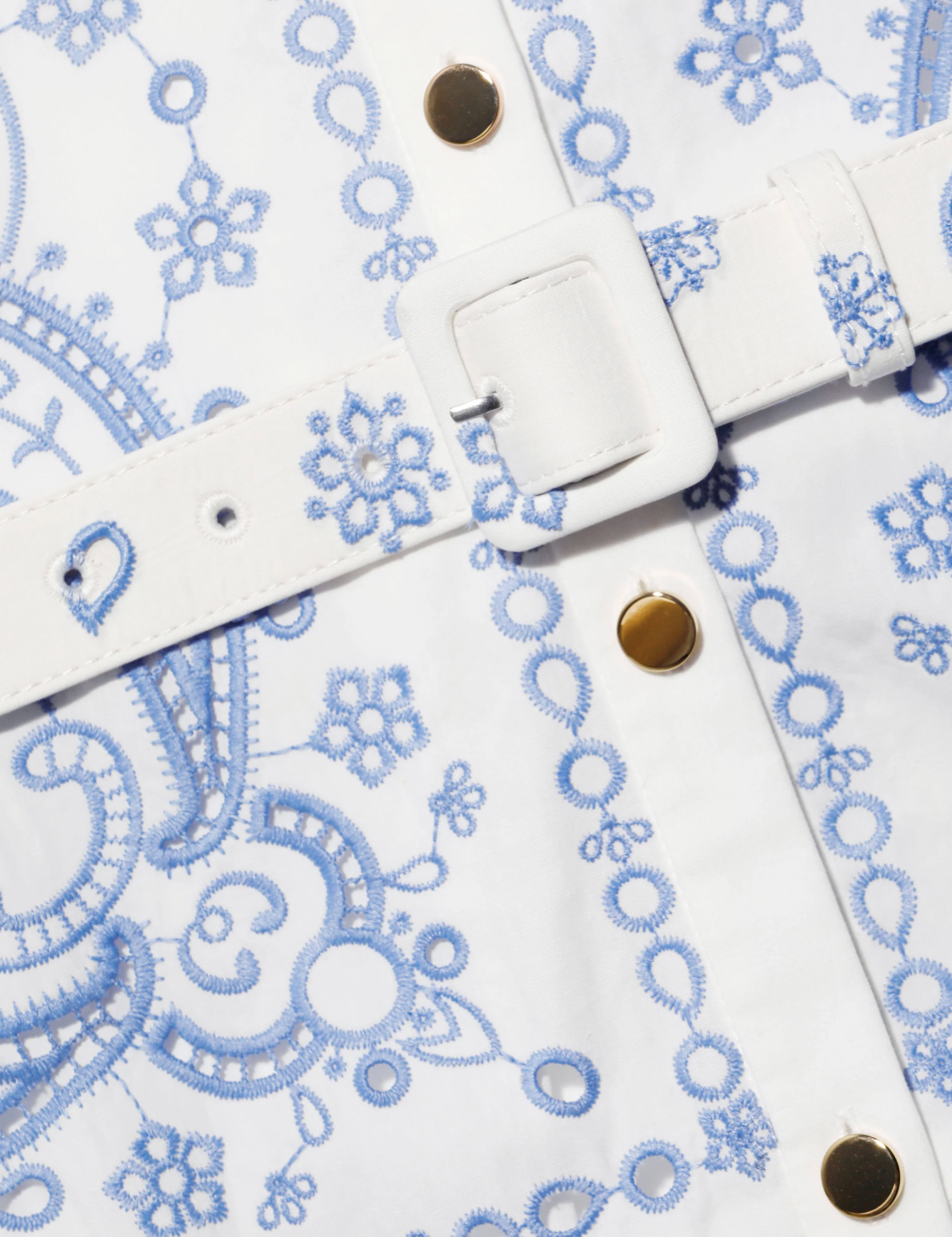White dress with blue lace patterns and gold buttons 