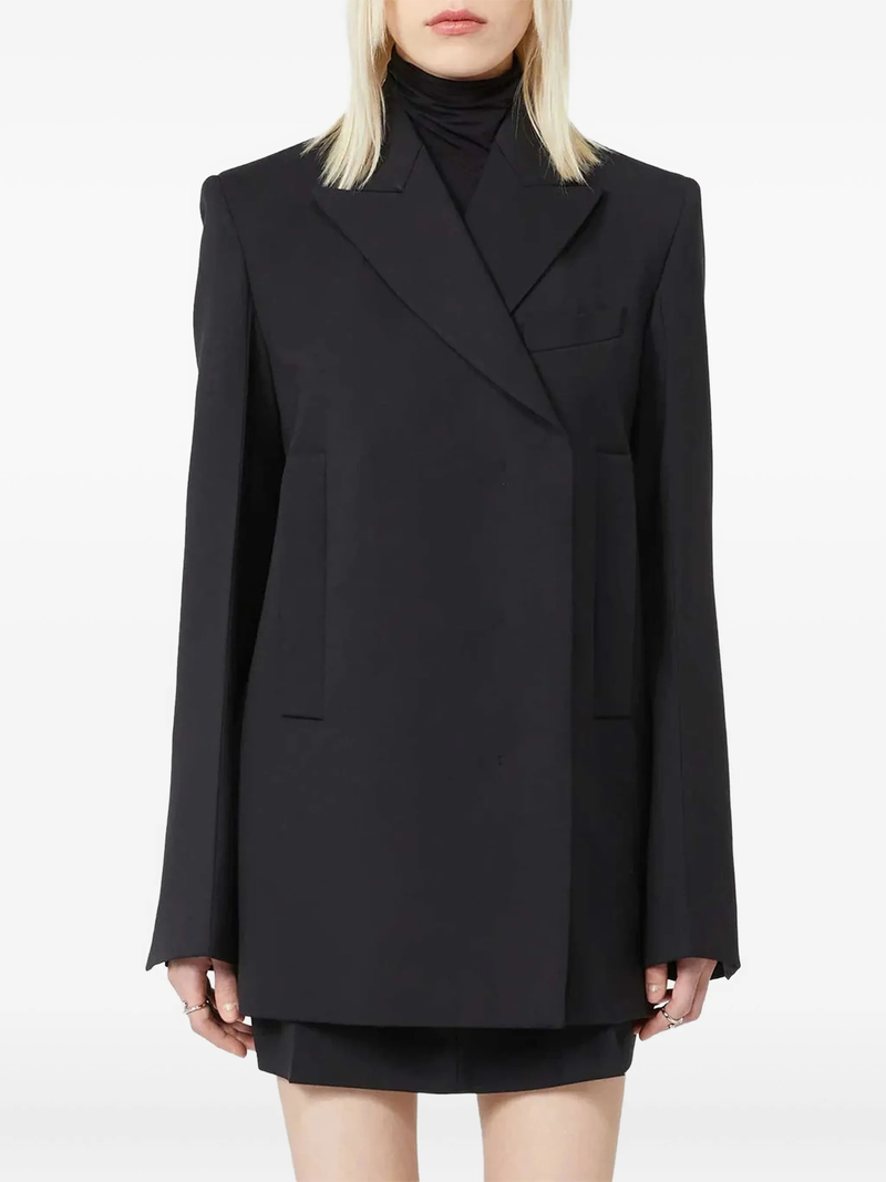 Black blazer worn by a person on a white background