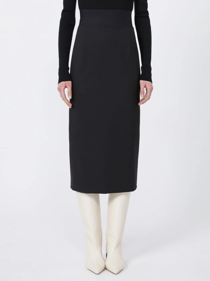 Person wearing a black skirt and white boots on a white background