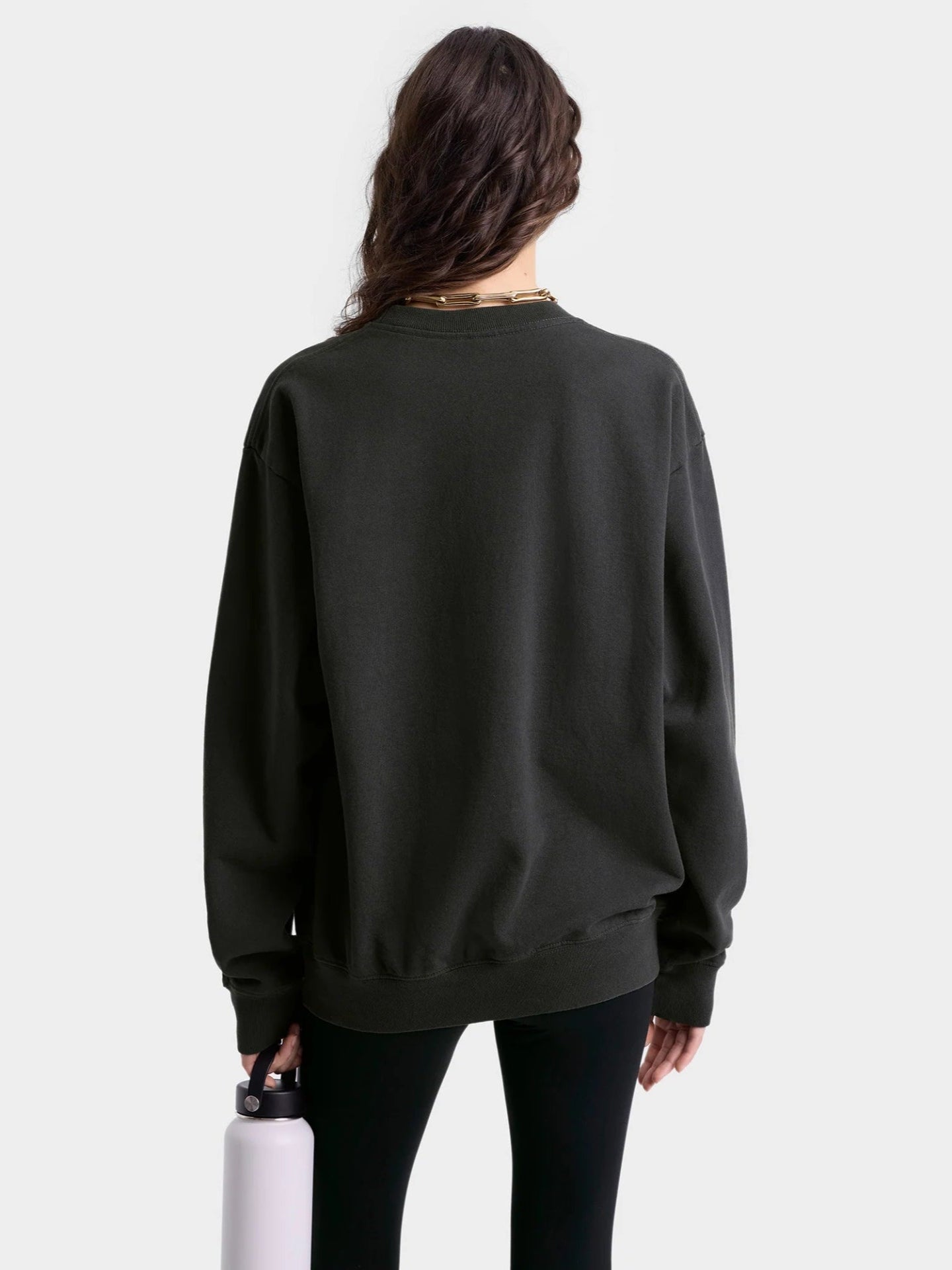 Person wearing a black sweatshirt on a white background
