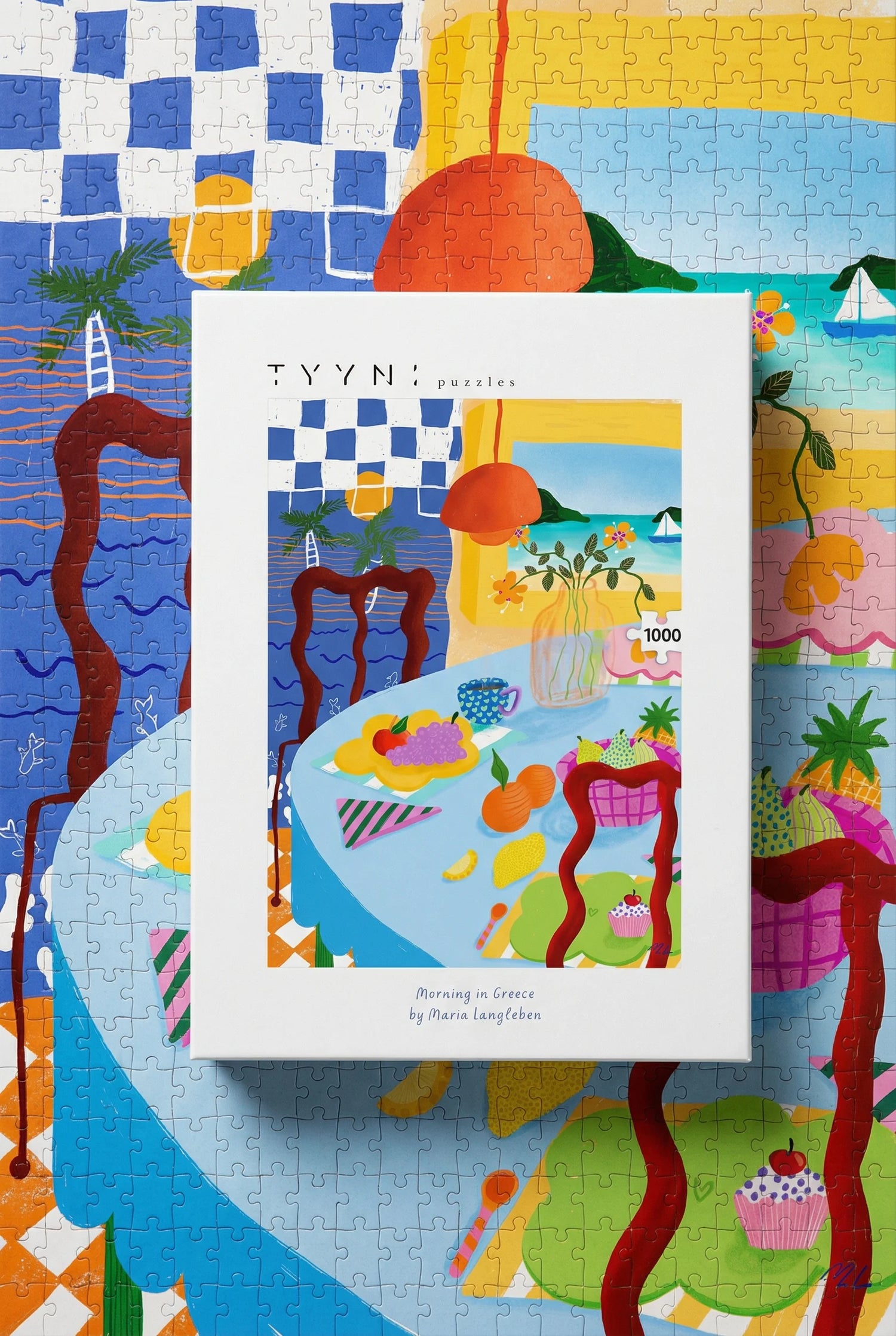 Puzzle box with colorful artwork on a checkered tablecloth