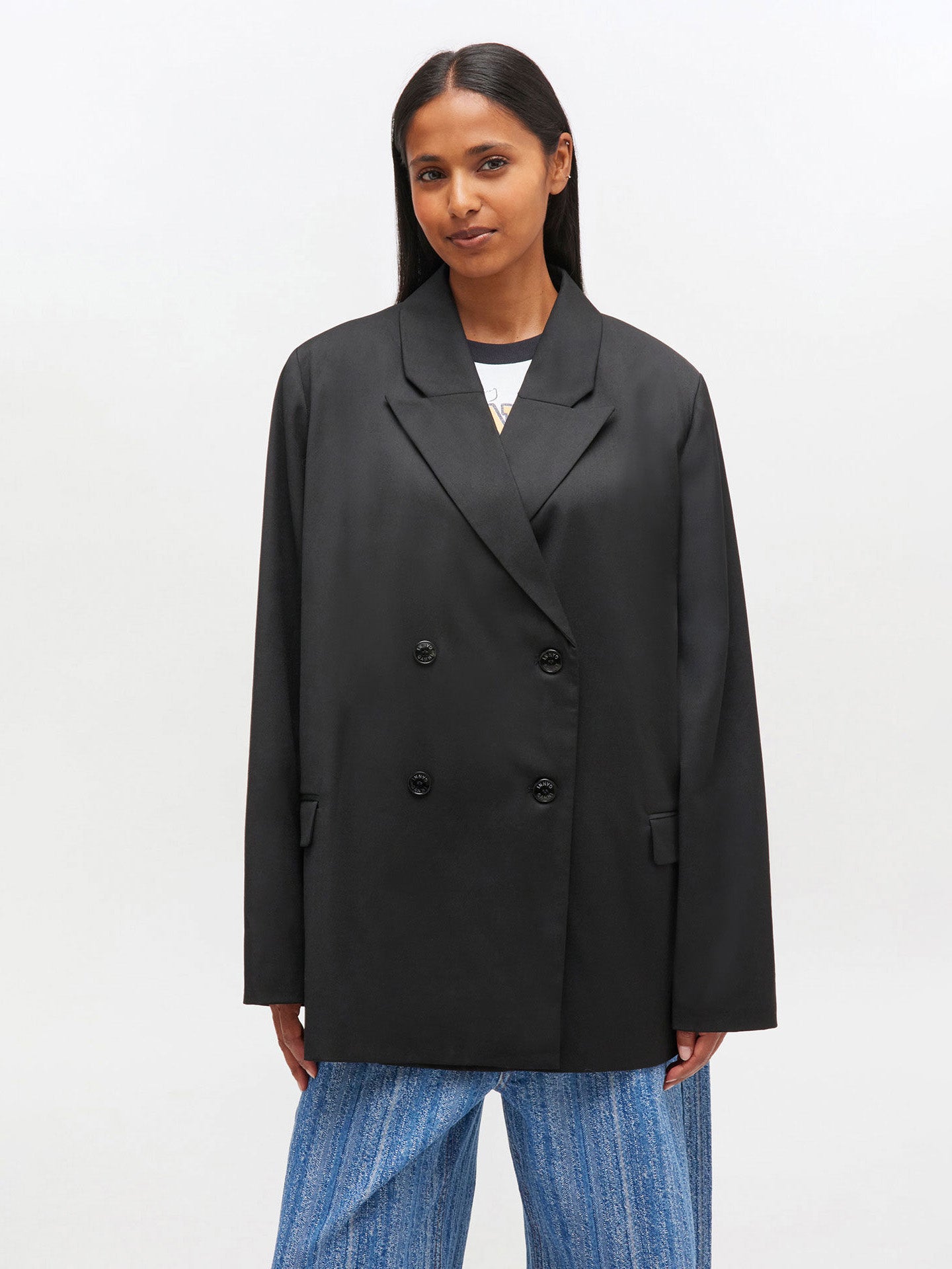 Woman wearing a black blazer on a white background