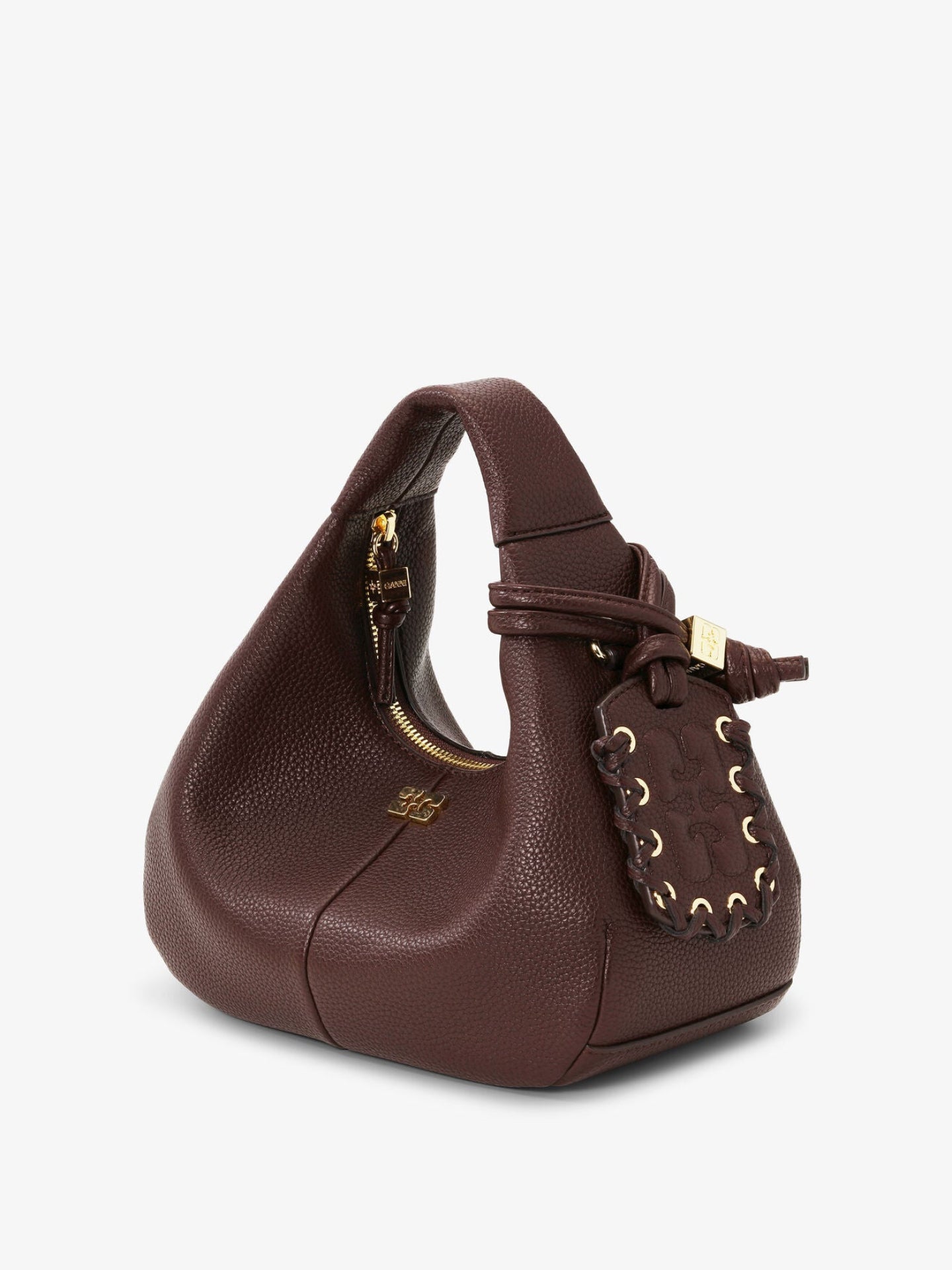 Brown leather handbag with decorative elements on a white background