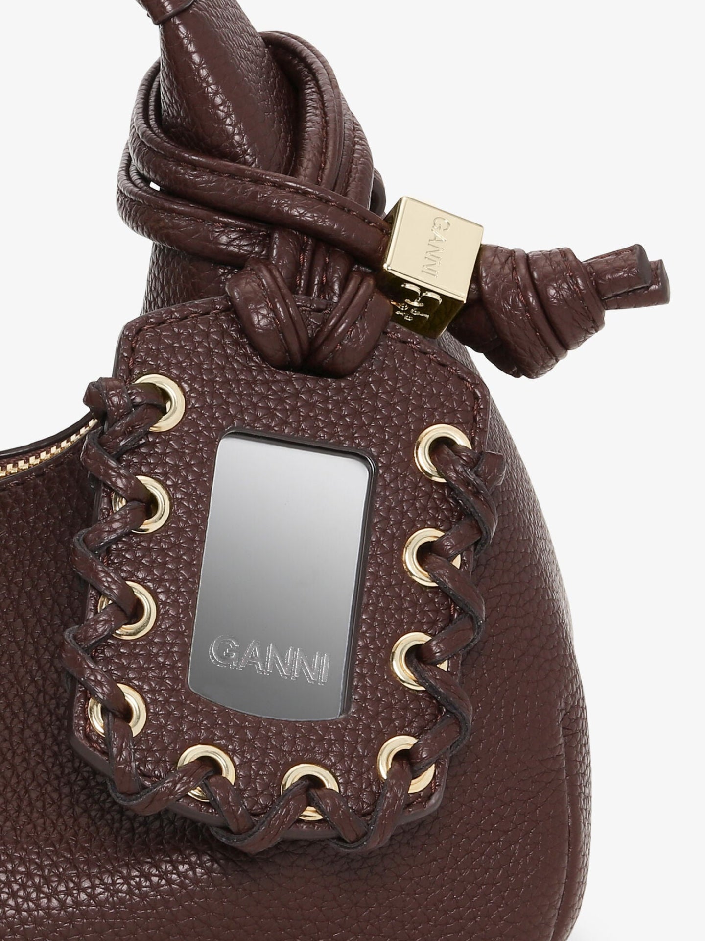 Brown leather bag with gold accents and a visible brand logo on a white background