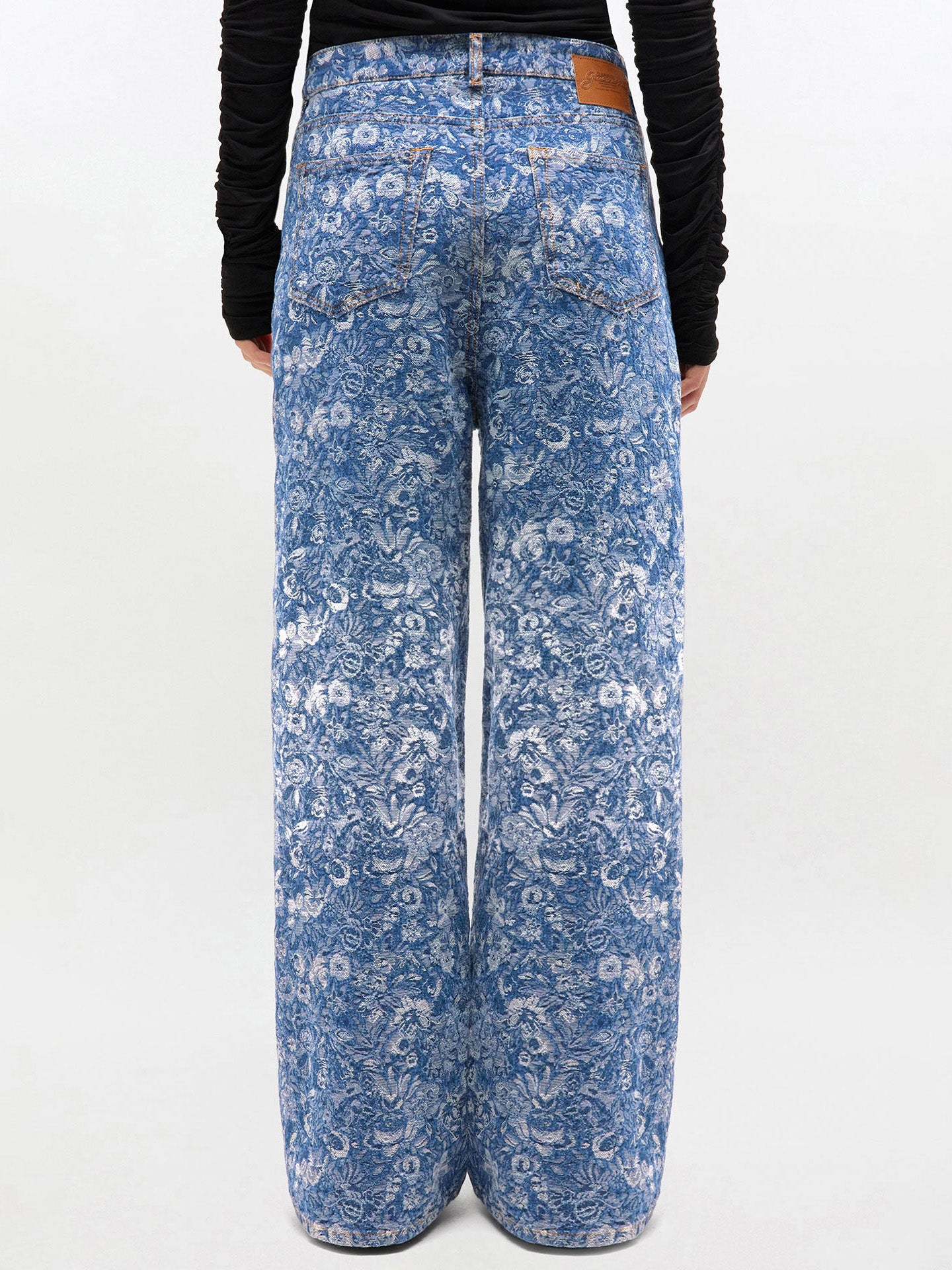Blue patterned pants worn by a person on a white background