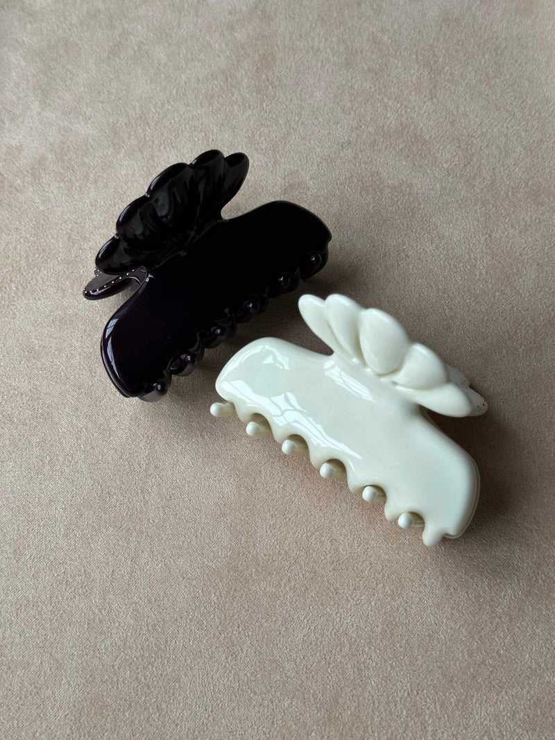 Black and white hair clips on a beige background