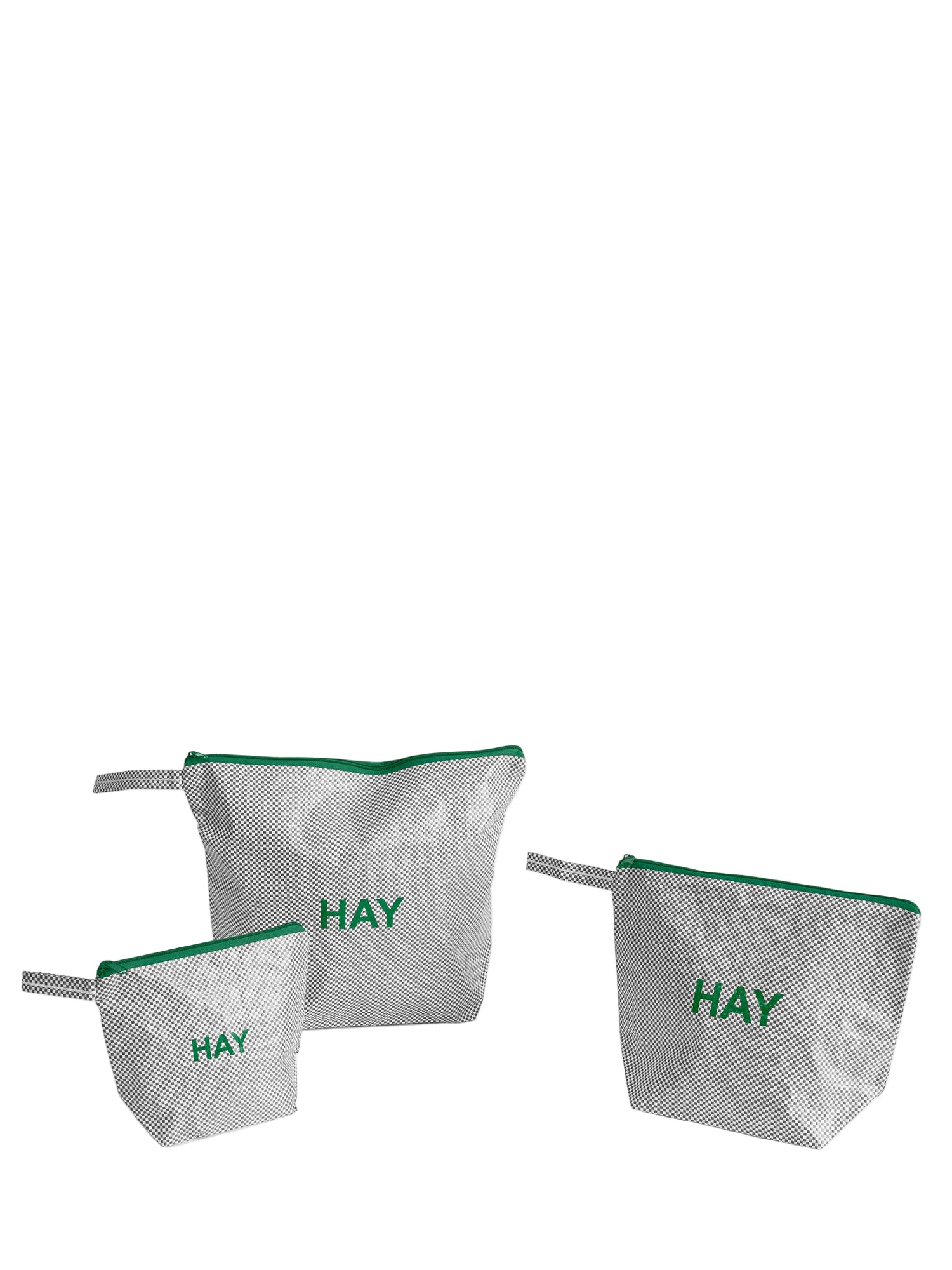 Three bags with green zippers and 'HAY' text on a white background