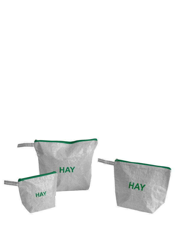 Three bags with green zippers and 'HAY' text on a white background