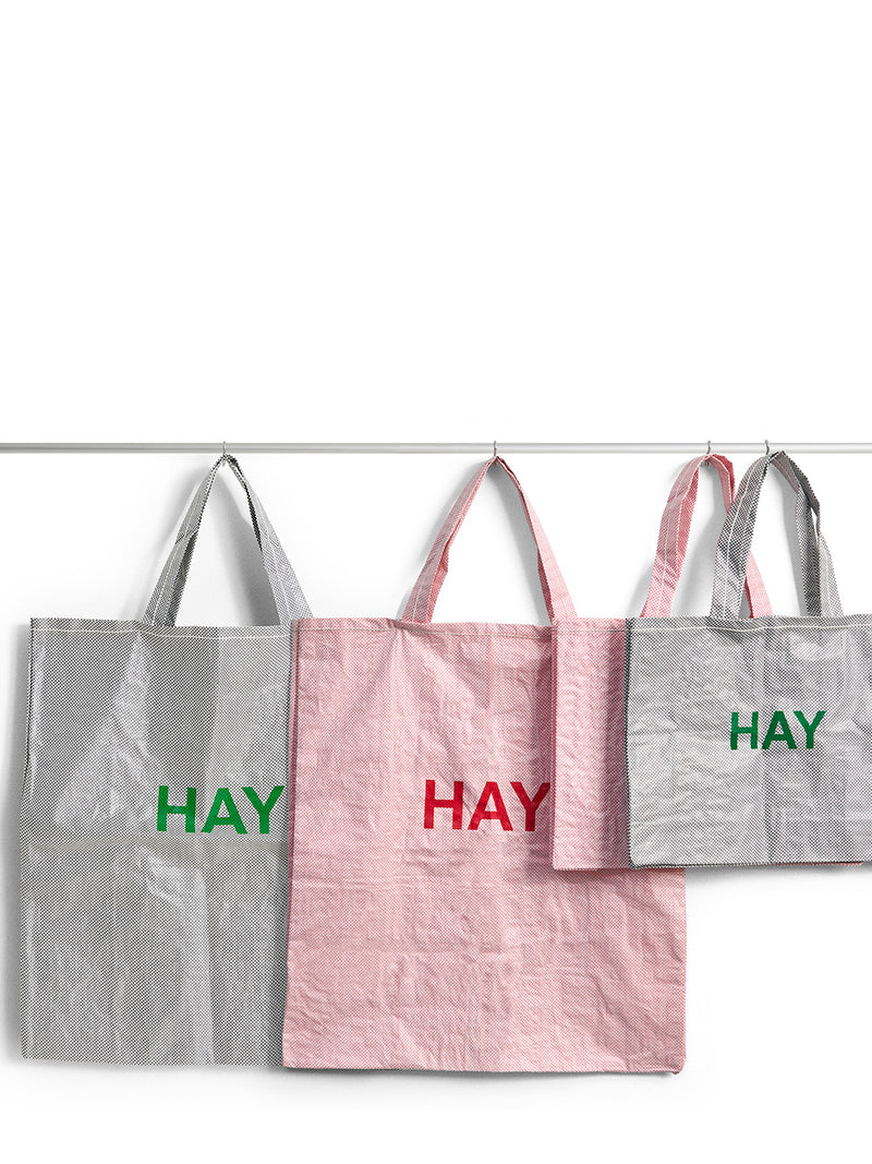 Three tote bags with 'HAY' text on a white background