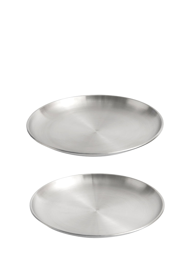 Two round brushed stainless steel plates with very slim design and low rim shown on a plain white background.