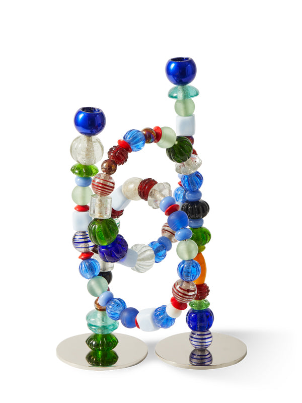 Colorful beaded candle holder on a white background