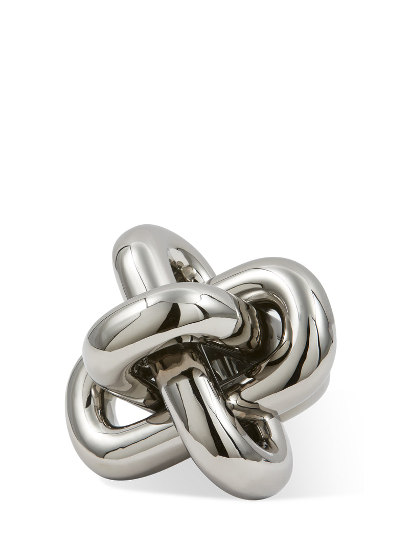 Silver knot-shaped object on a white background